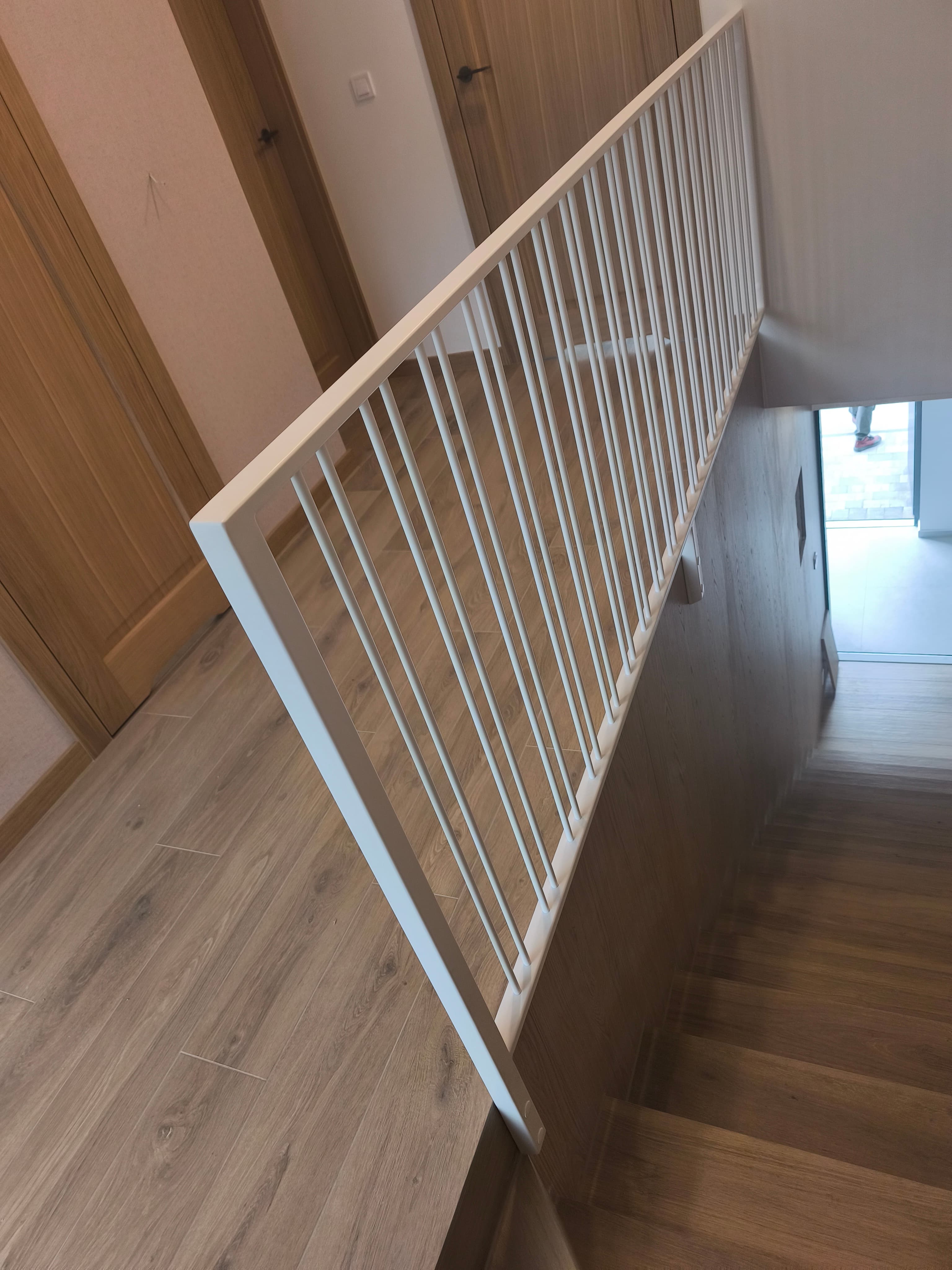 Biała balustrada metalowa na drewnianych schodach – nowoczesna